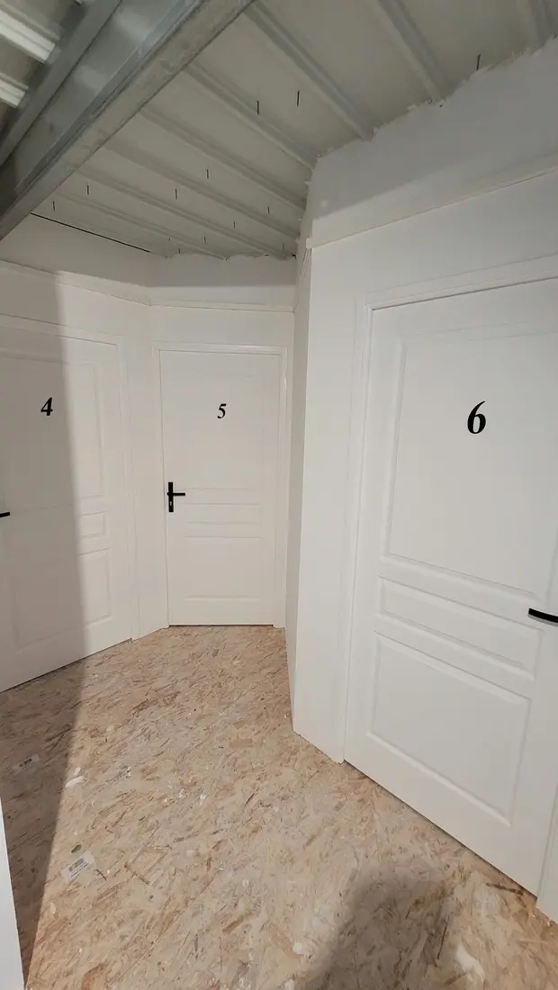 Couloir de l'étage avec les portes numérotées des box de stockage